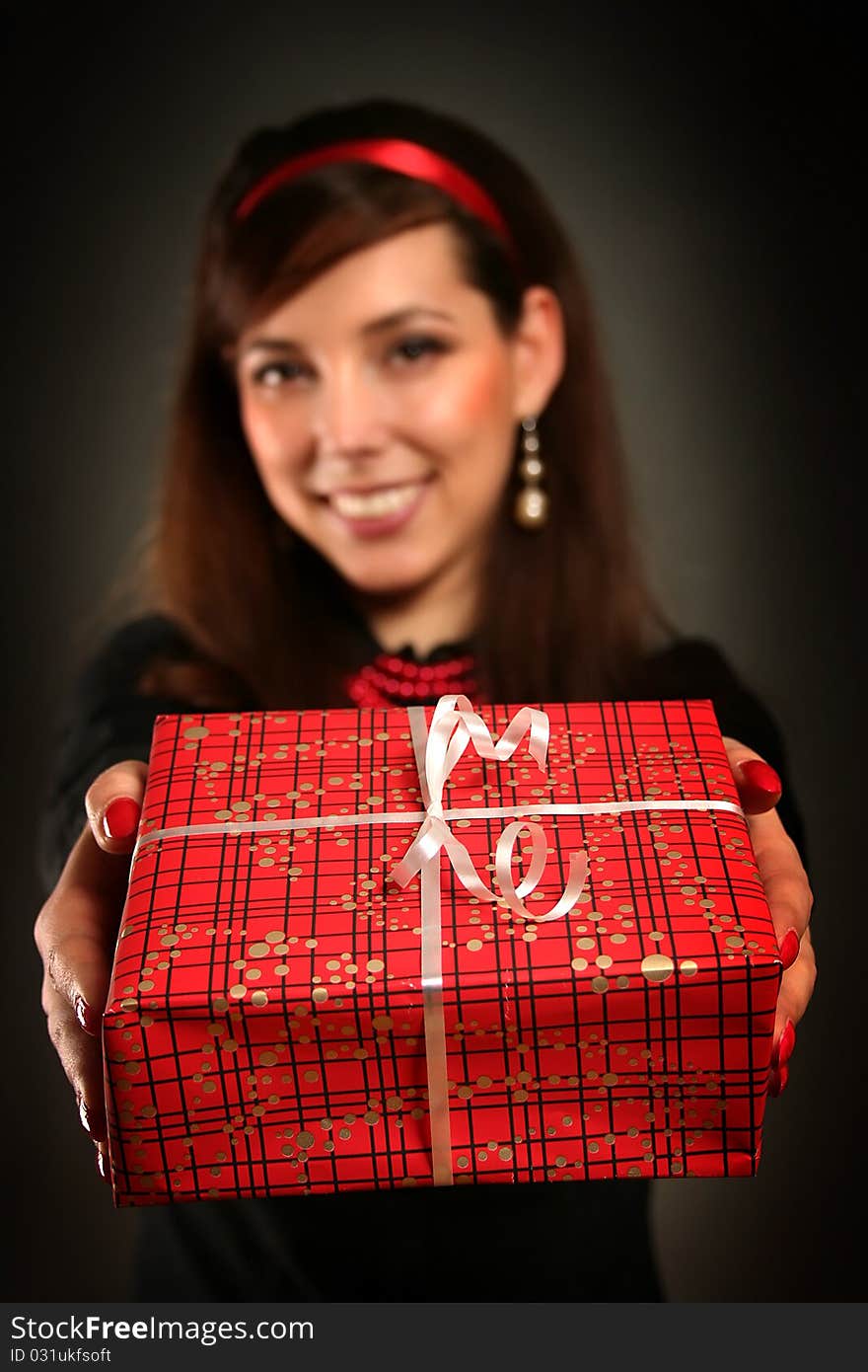 Beautiful retro woman with red present. Beautiful retro woman with red present