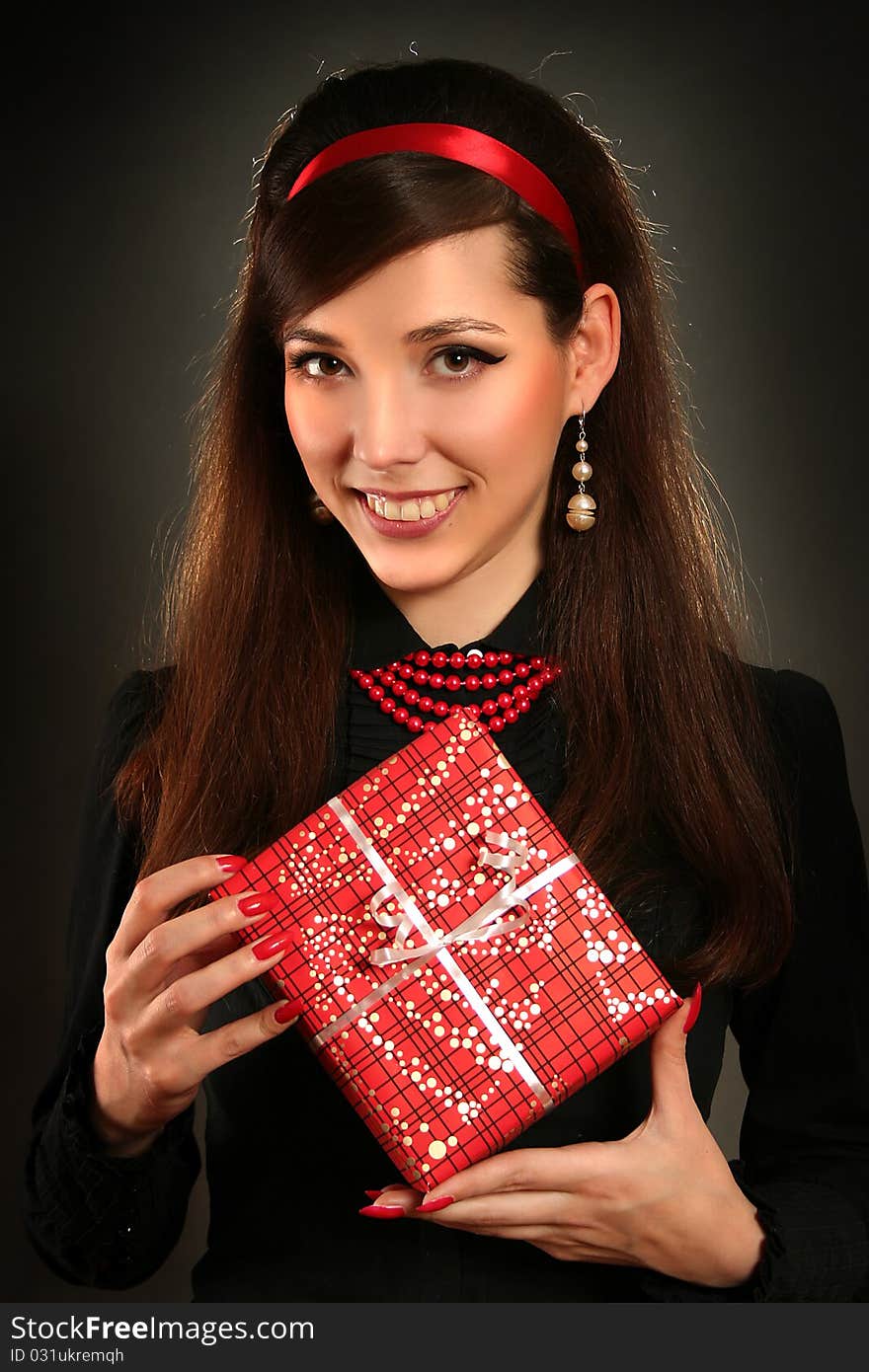 Beautiful retro woman with red present. Beautiful retro woman with red present