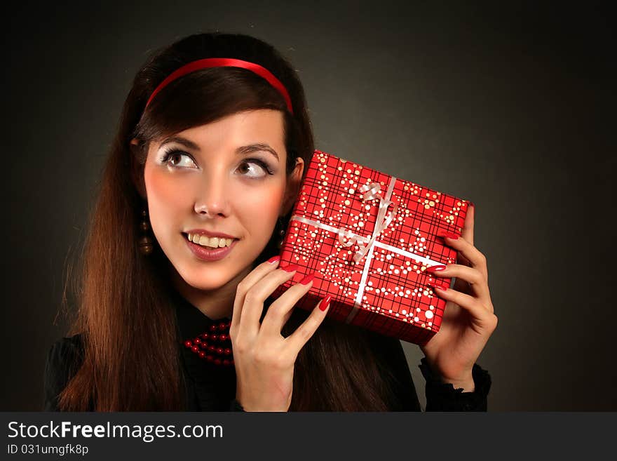 Beautiful retro woman with red present. Beautiful retro woman with red present