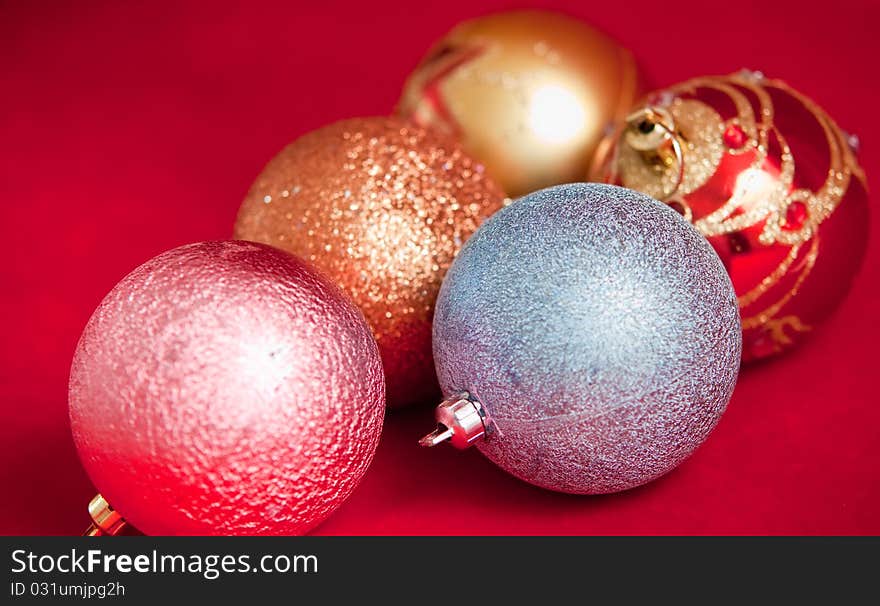 Varicoloured christmas balls on red  background  . Varicoloured christmas balls on red  background  .