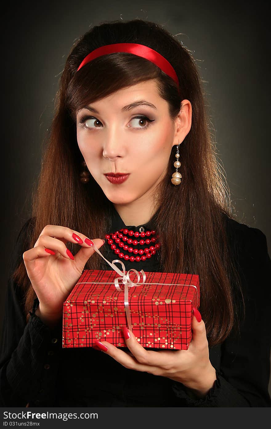 Beautiful retro woman with red present. Beautiful retro woman with red present