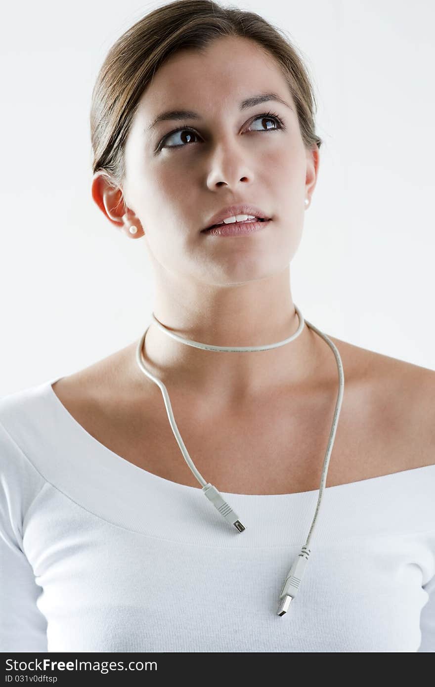 Woman wearing computer cable as necklace. Concepts: thinking only about work.