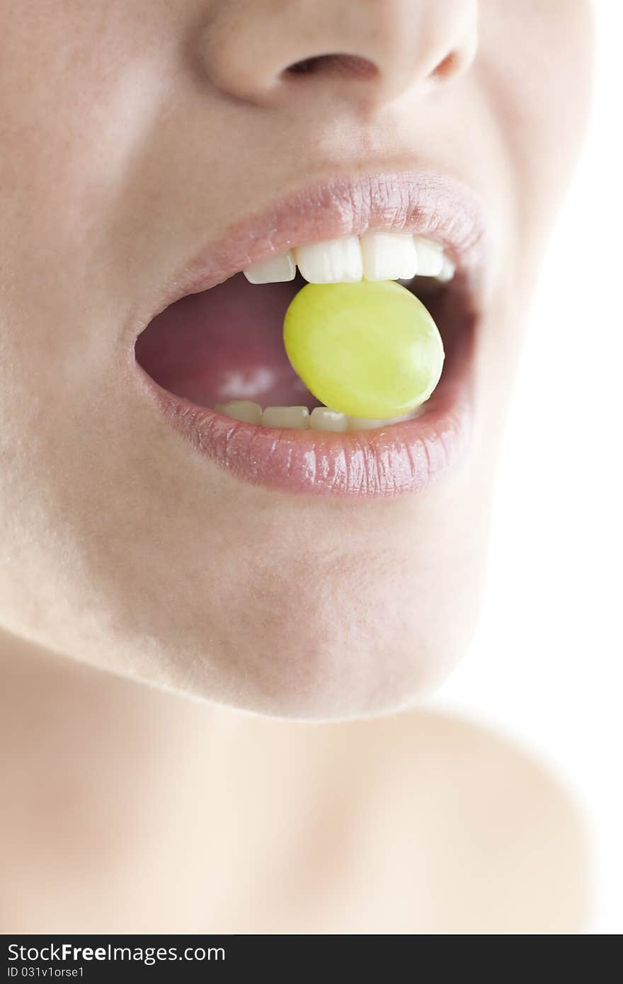 Young woman with grape in mouth. Young woman with grape in mouth