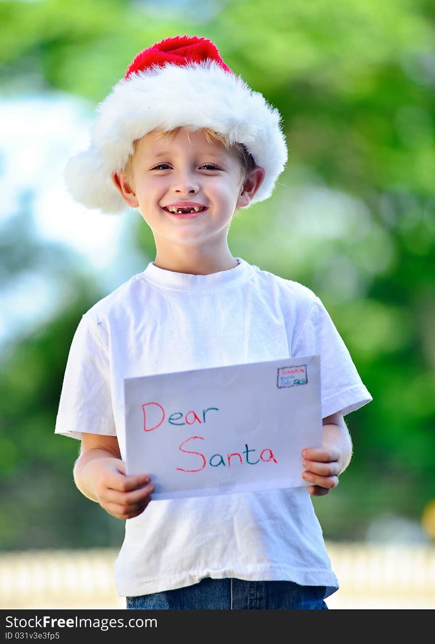 Young child holds letter for Santa Claus. Young child holds letter for Santa Claus