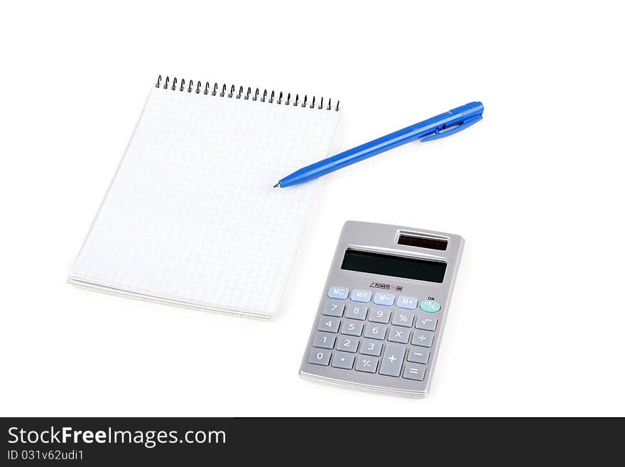 Calculator and paper notebook with blue pen, closeup on white