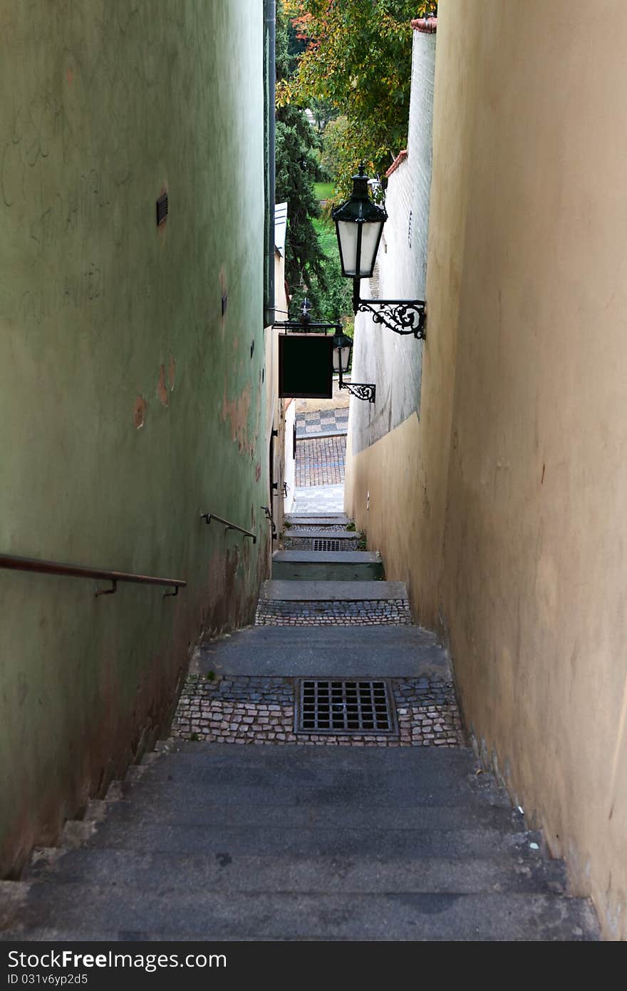 The narrow street in Prague with the steps overlooking the park