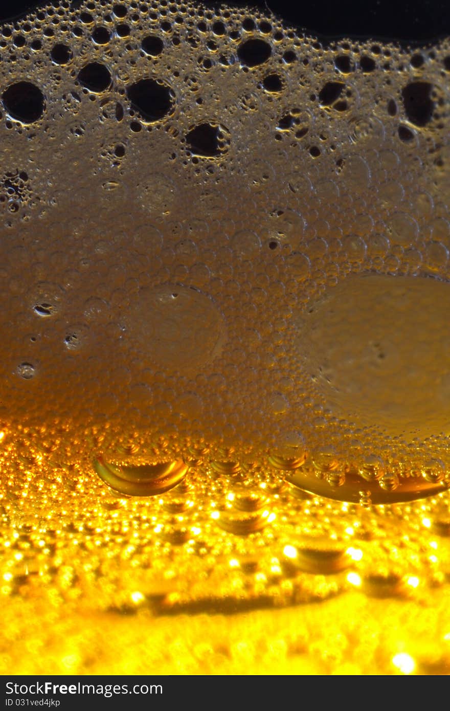 Macro shot of light beer with froth. Macro shot of light beer with froth.