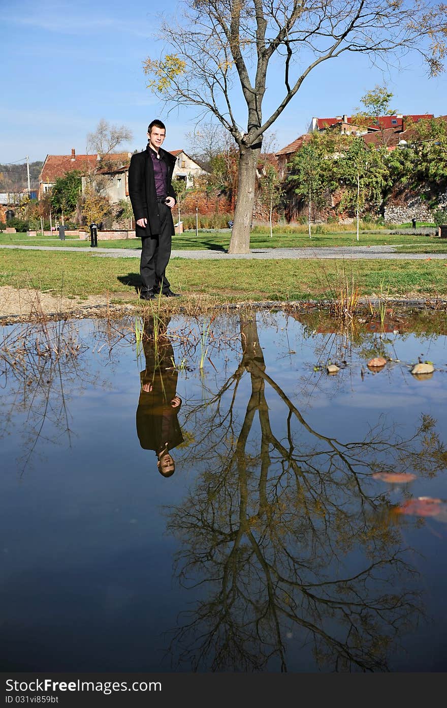 Portrait of an attractive man reflected in the lake. Portrait of an attractive man reflected in the lake