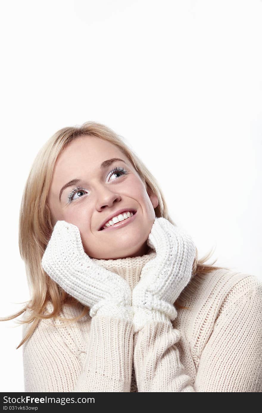 Attractive girl looks up in mittens on a white background. Attractive girl looks up in mittens on a white background