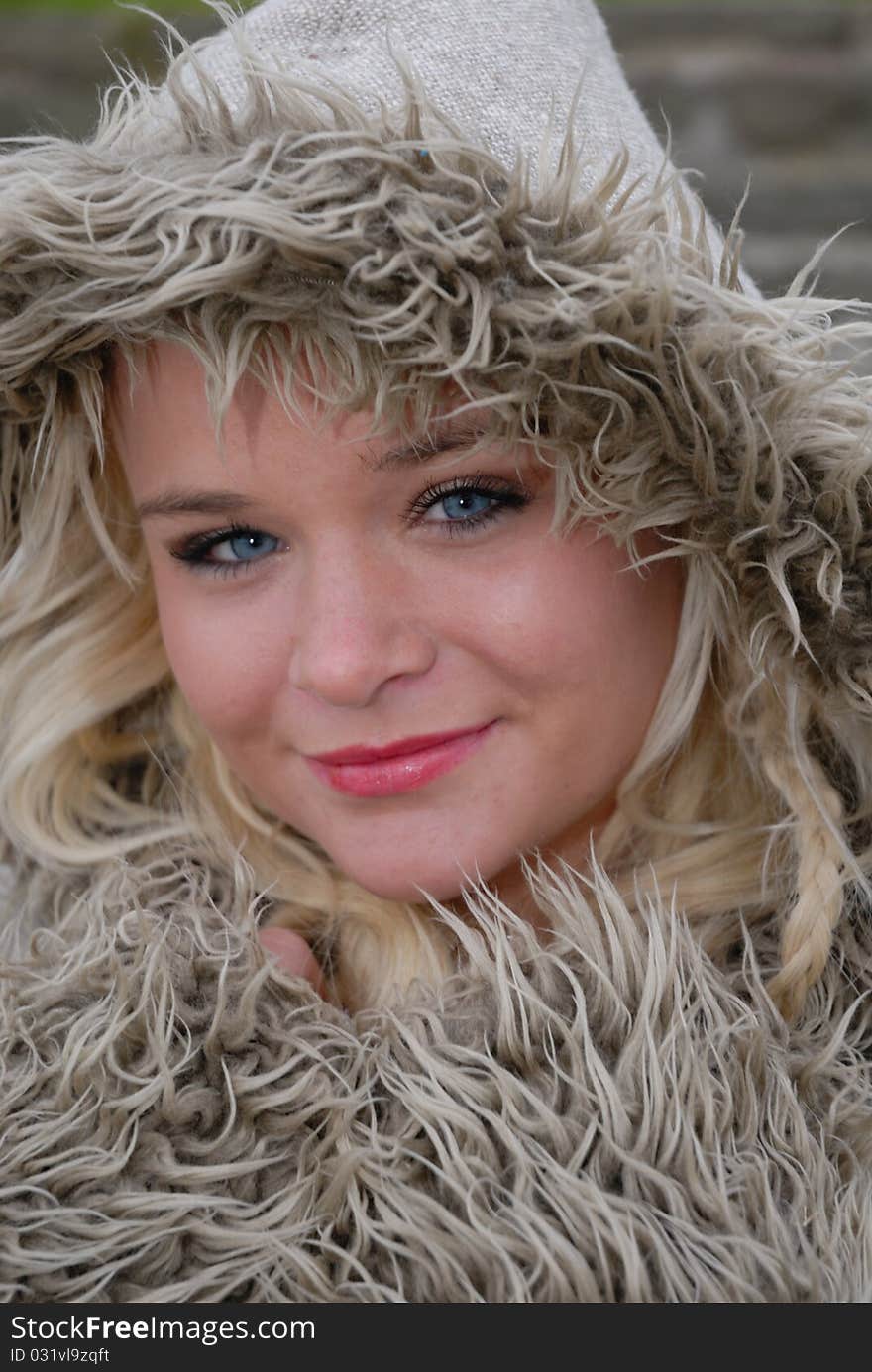 Image showing beautiful young female in warm coat and hood outdoors. Image showing beautiful young female in warm coat and hood outdoors