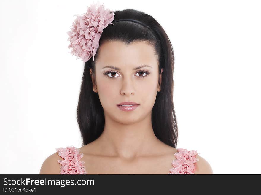 Portrait of young woman in pink dress smiling against white background