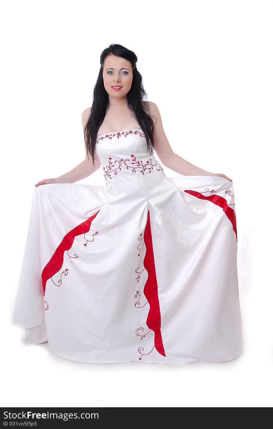 Photograph showing cute young bride in white and red wedding dress isolated against white