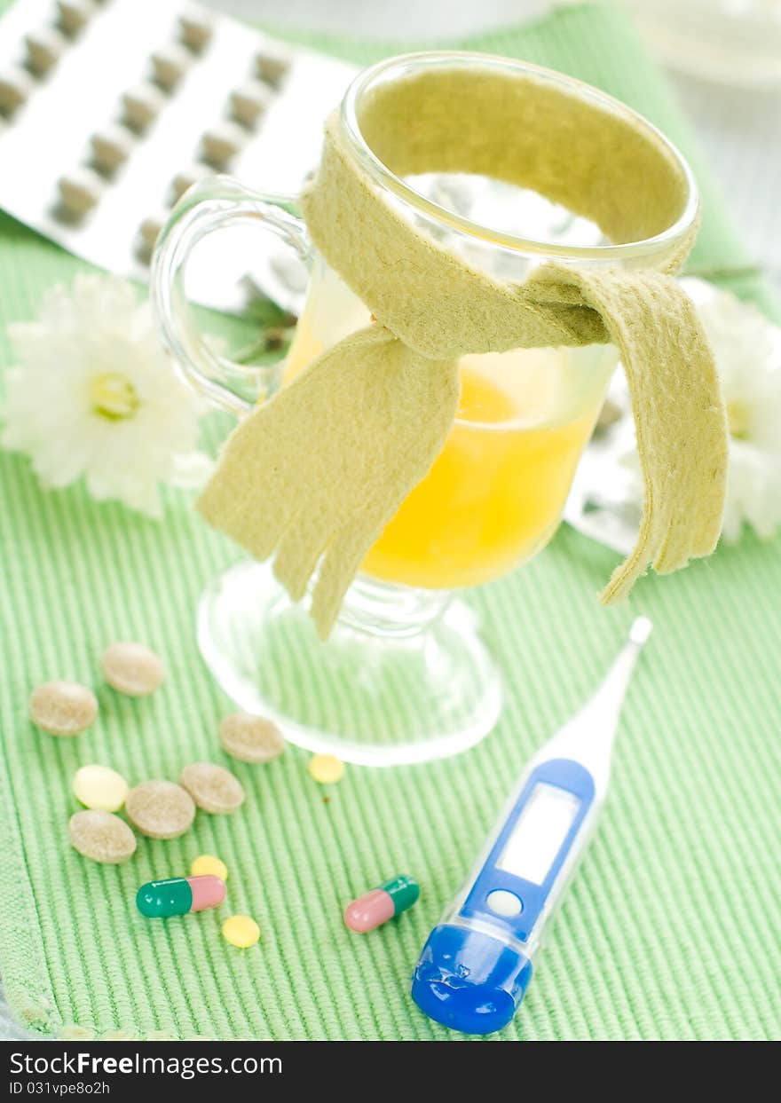 Hot drink with thermometer and pills