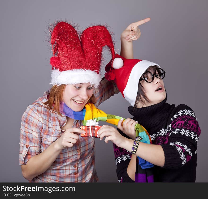 Two funny girls with christmas gifts.