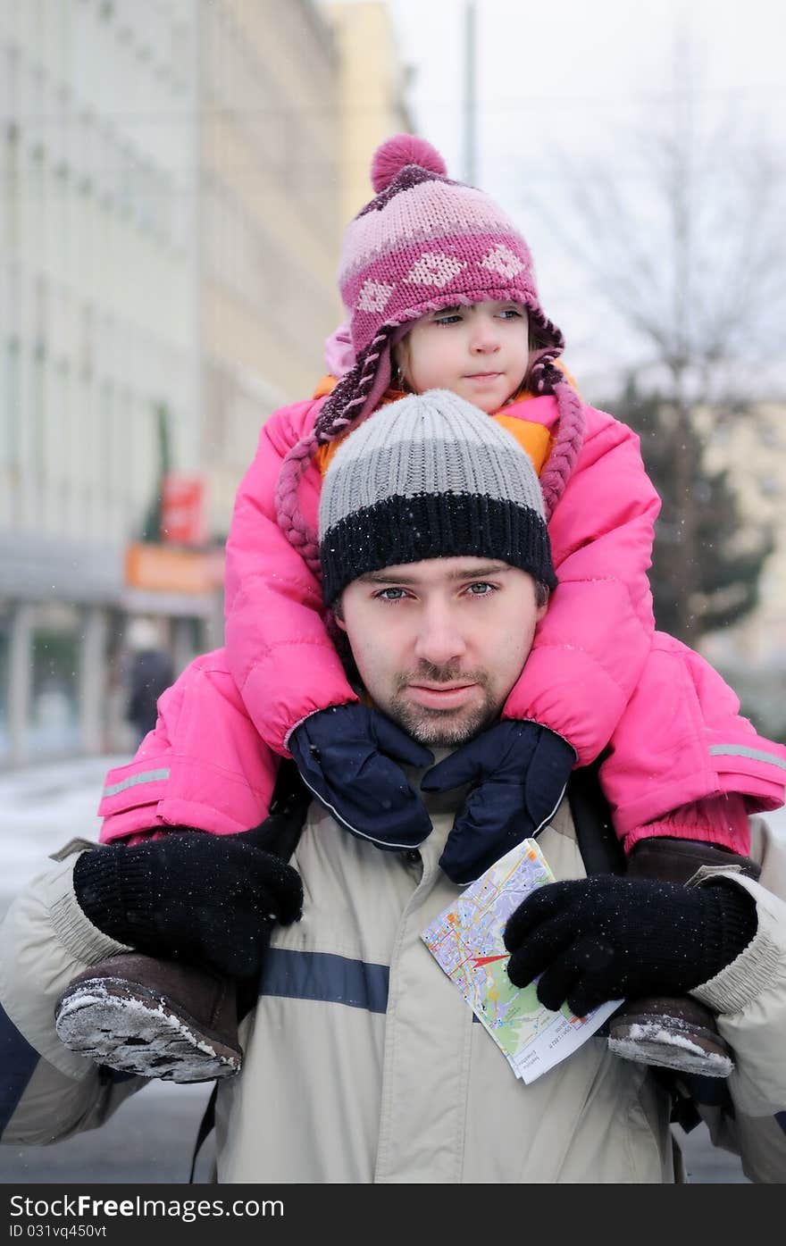 Young father gives his daughter a ride on his back