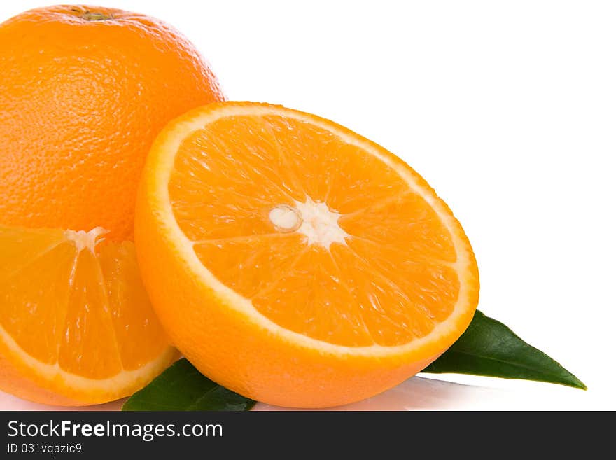 Oranges and green leaves  isolated on white background