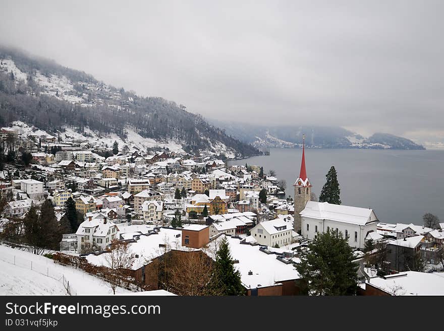 Winter view of small town and mountain lake