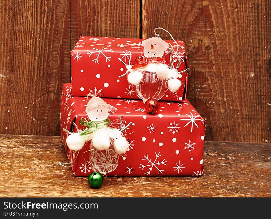 Snowman and gift boxes on wood background. Snowman and gift boxes on wood background