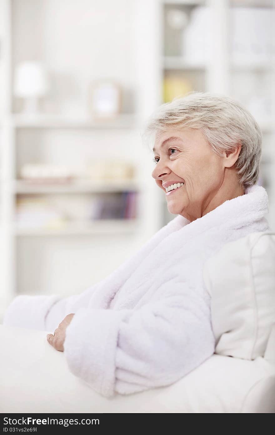 Mature woman smiling in a white coat. Mature woman smiling in a white coat