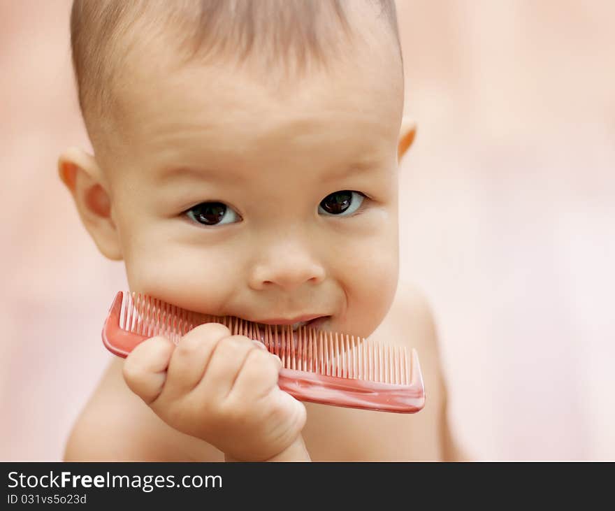 A small child learns to comb hair brush for hair