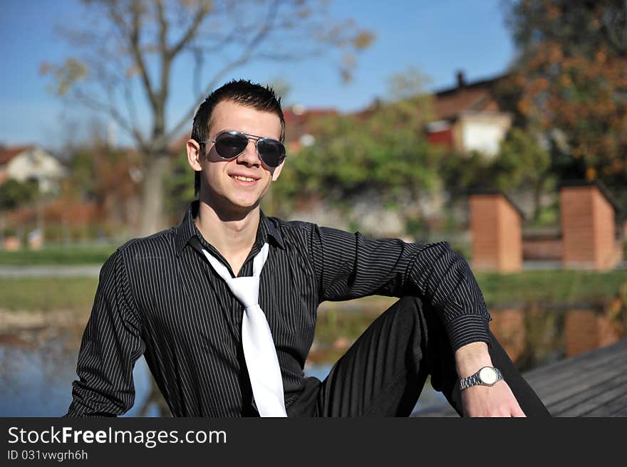 Portrait of an attractive man on a pontoon near a lake. Portrait of an attractive man on a pontoon near a lake