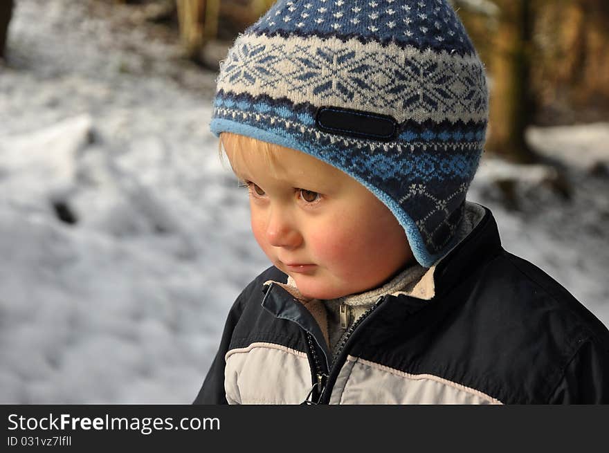 Boy Standing In Snowy Forest