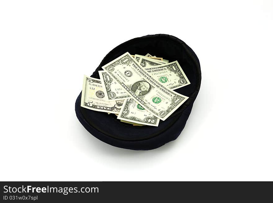 Dollars in a cap on a white background. Dollars in a cap on a white background.