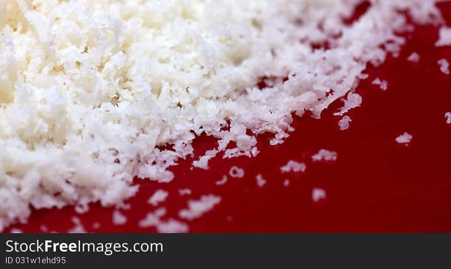 Parmesan cheese on red background