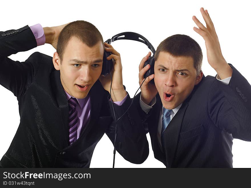 Two young people listening on headphone about something and wondering. Two young people listening on headphone about something and wondering