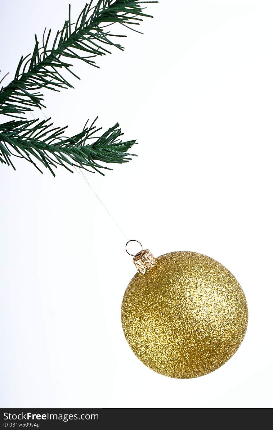 Golden christmas ball on green brunch. Golden christmas ball on green brunch