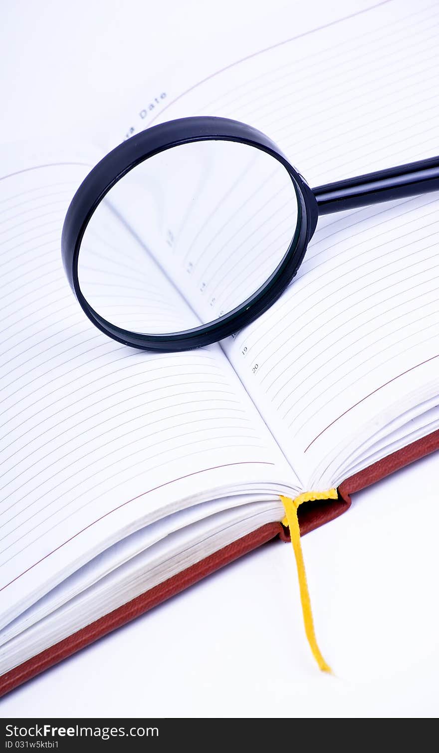 Book with magnifying glass on white background