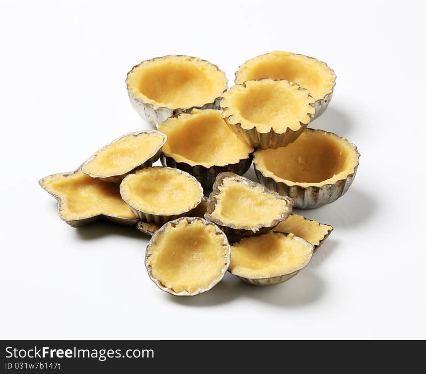 Raw dough in tartlet pans