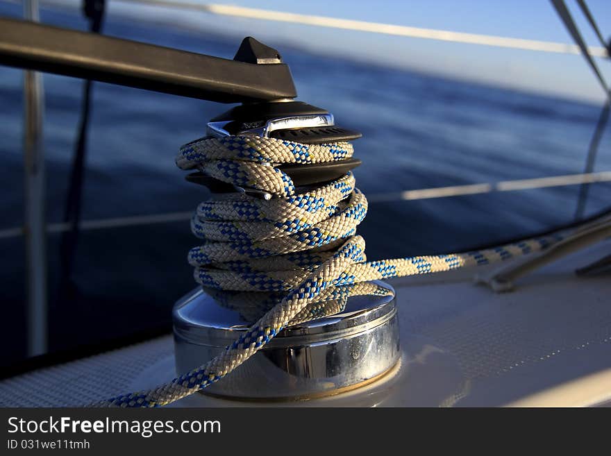 A sailboat winch and a blue ocean