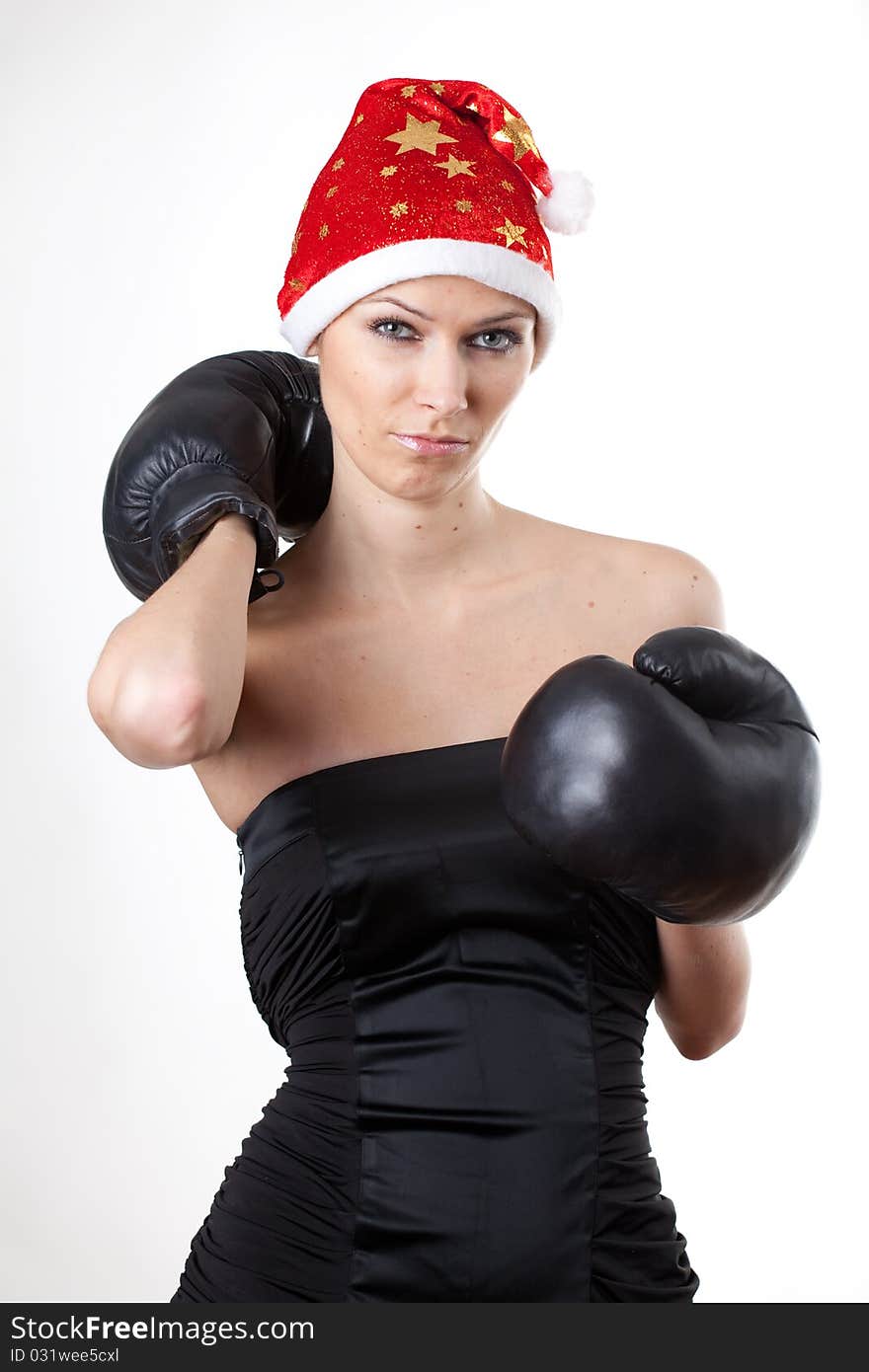 Young girl in Santa Claus hat with boxing gloves. Young girl in Santa Claus hat with boxing gloves