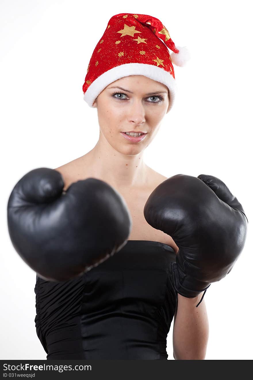 Young girl in Santa Claus hat with boxing gloves. Young girl in Santa Claus hat with boxing gloves