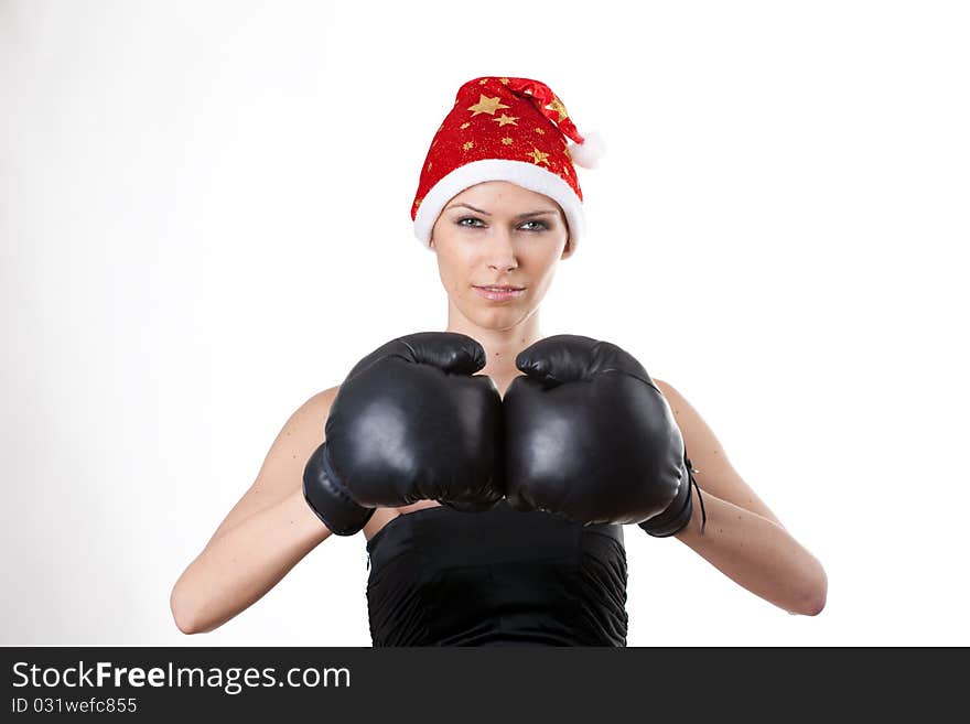 Young girl in Santa Claus hat with boxing gloves. Young girl in Santa Claus hat with boxing gloves