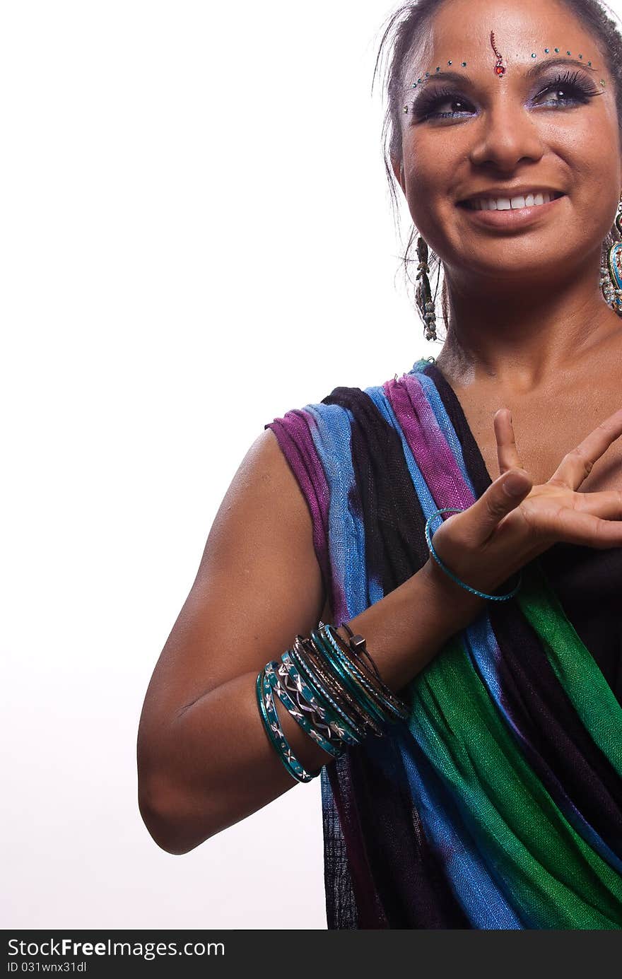 Beautiful young woman in Indian sari with expressive hands in a gesture that says Voila (or the Hindu equivalent) after a Bollywood-themed performance. Lovely smile, plenty of copy space at left. Beautiful young woman in Indian sari with expressive hands in a gesture that says Voila (or the Hindu equivalent) after a Bollywood-themed performance. Lovely smile, plenty of copy space at left.