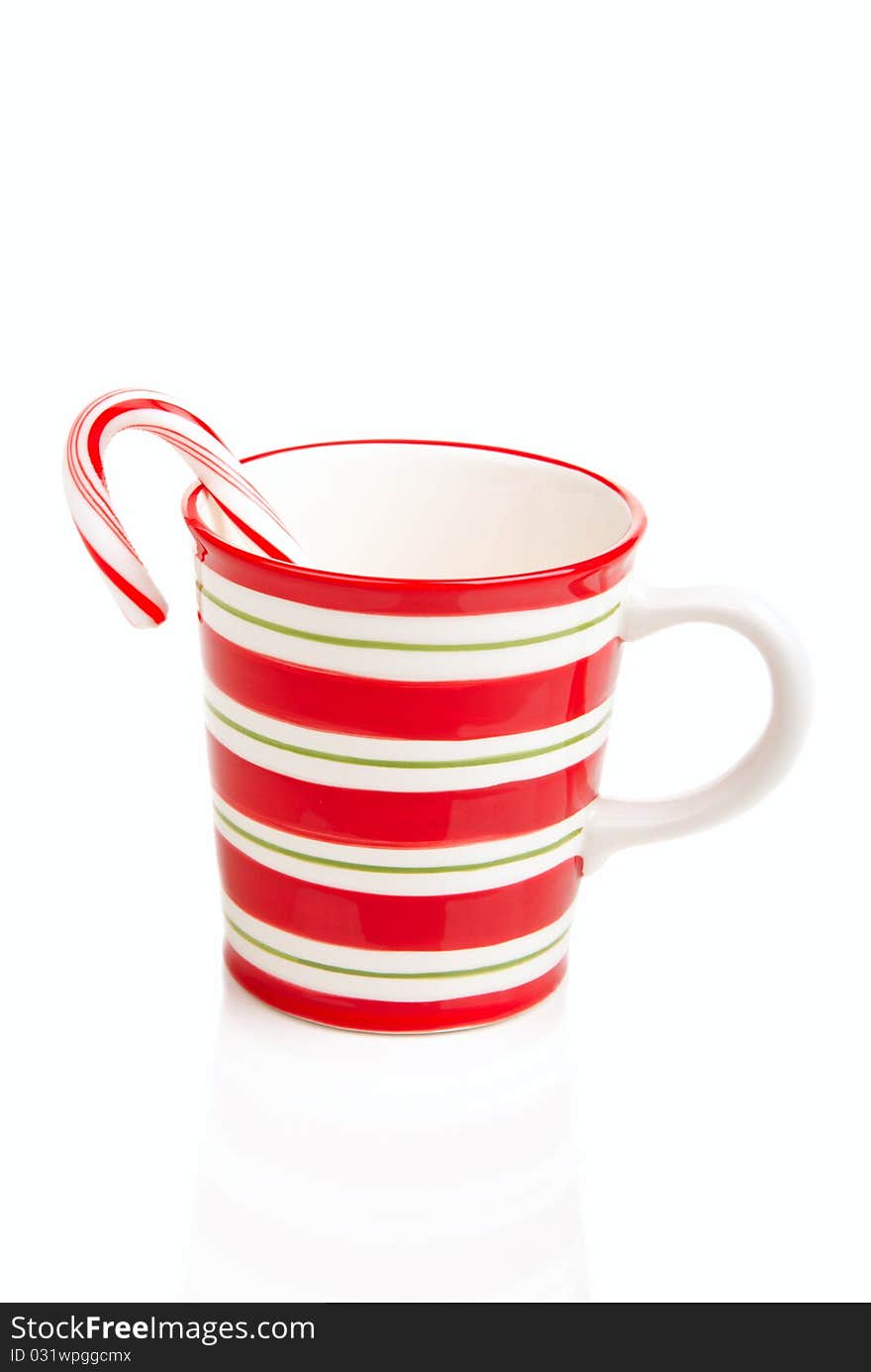 Red striped Christmas cup with candy cane isolated ona white background