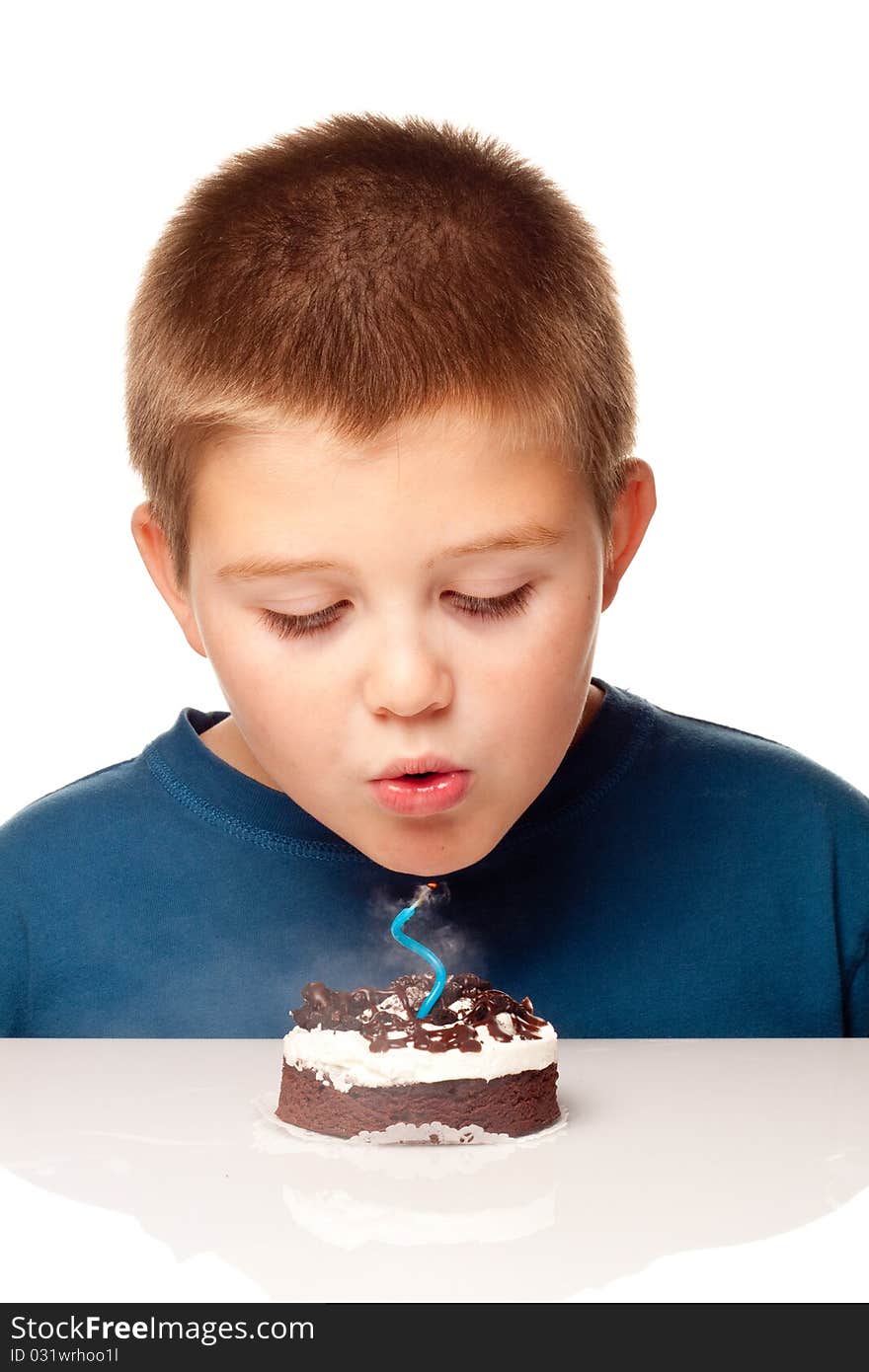 Young Boy deciding to eat a dessert and making a wish