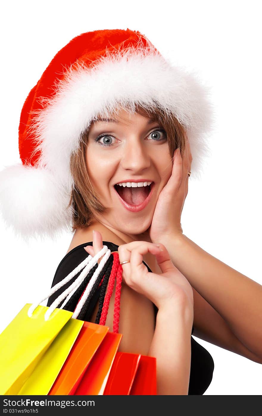 Christmas woman holding shopping bags wearing Santa hat. Isolated on white background. Christmas woman holding shopping bags wearing Santa hat. Isolated on white background.