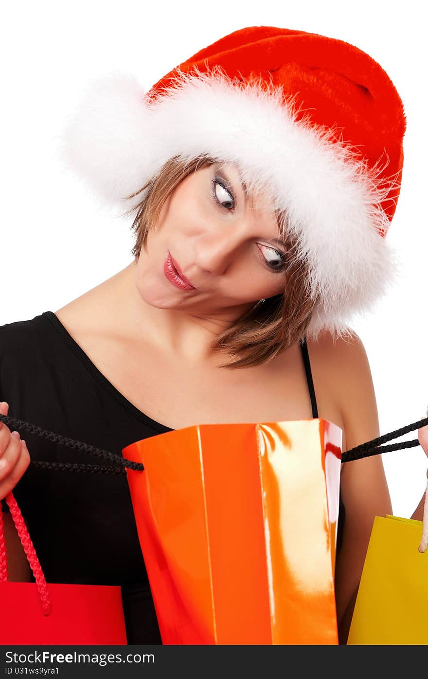 Christmas woman holding shopping bags wearing Santa hat. Isolated on white background. Christmas woman holding shopping bags wearing Santa hat. Isolated on white background.