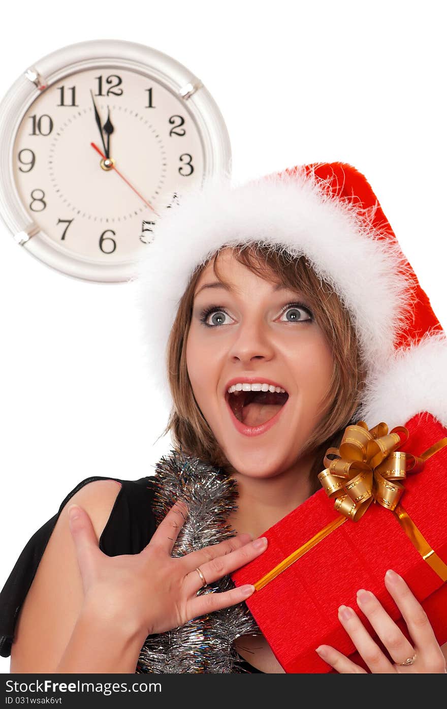 Emotional beautiful christmas girl holding gift wearing Santa hat