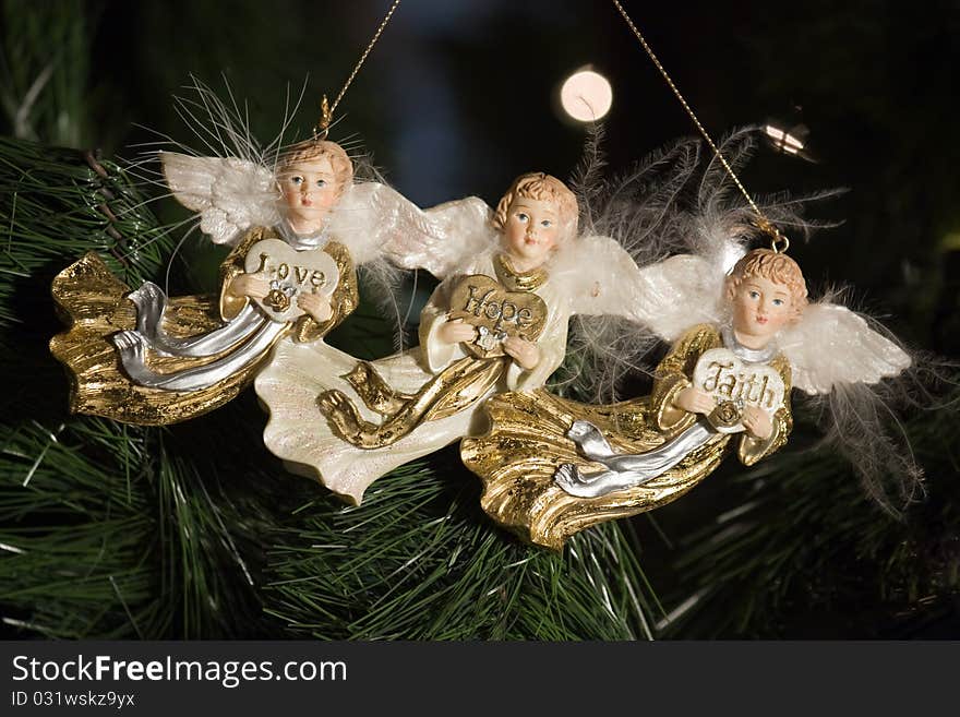 A set of three angels hanging on a tree. A set of three angels hanging on a tree.