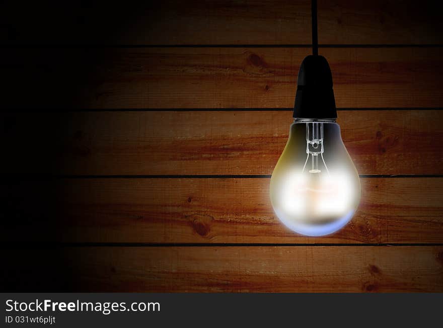 Light bulb over wooden background