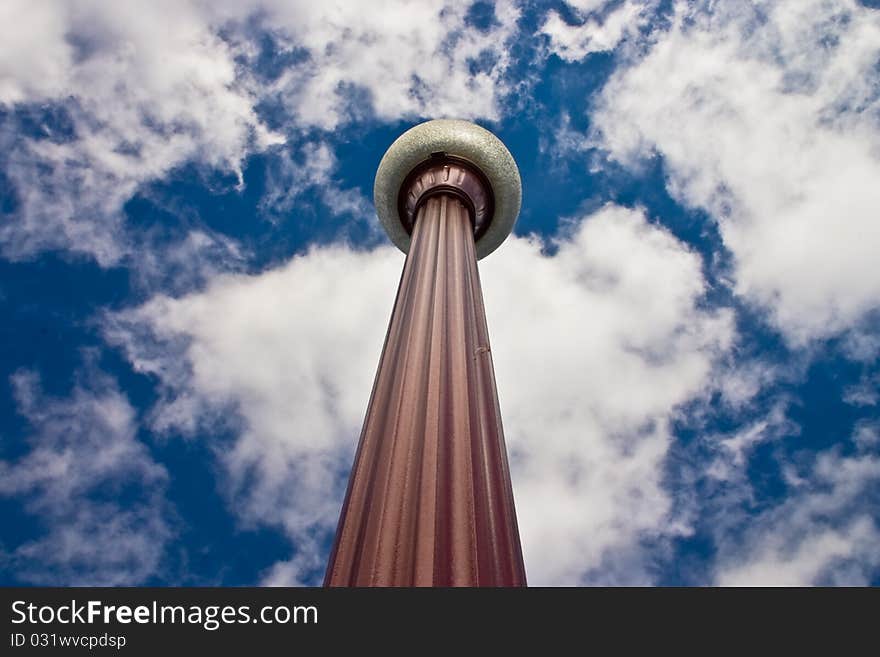 A street lamp against a vivid blue sky.