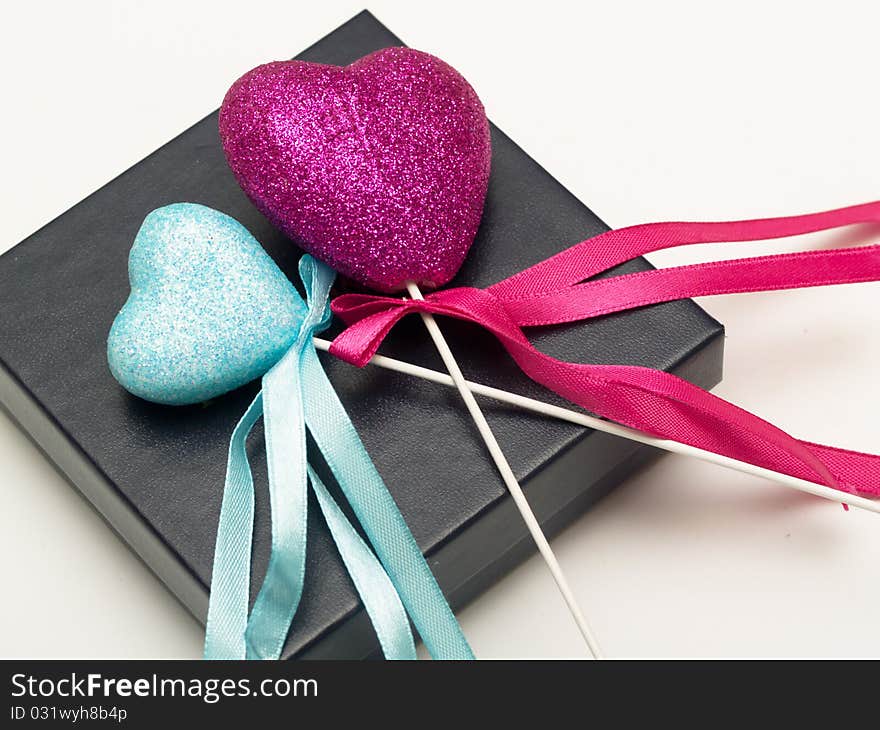 Pink and blue hearts on a black gift box