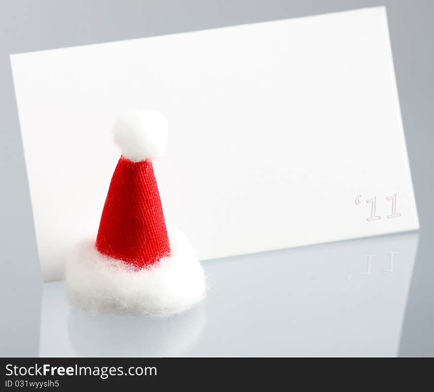 Clear New Year Card And Hat Of Santa Claus