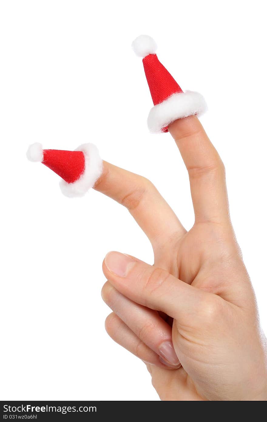 A hand with small Santas caps on fingers isolated on white