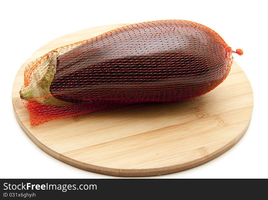 Aubergine in the net and onto wood plates