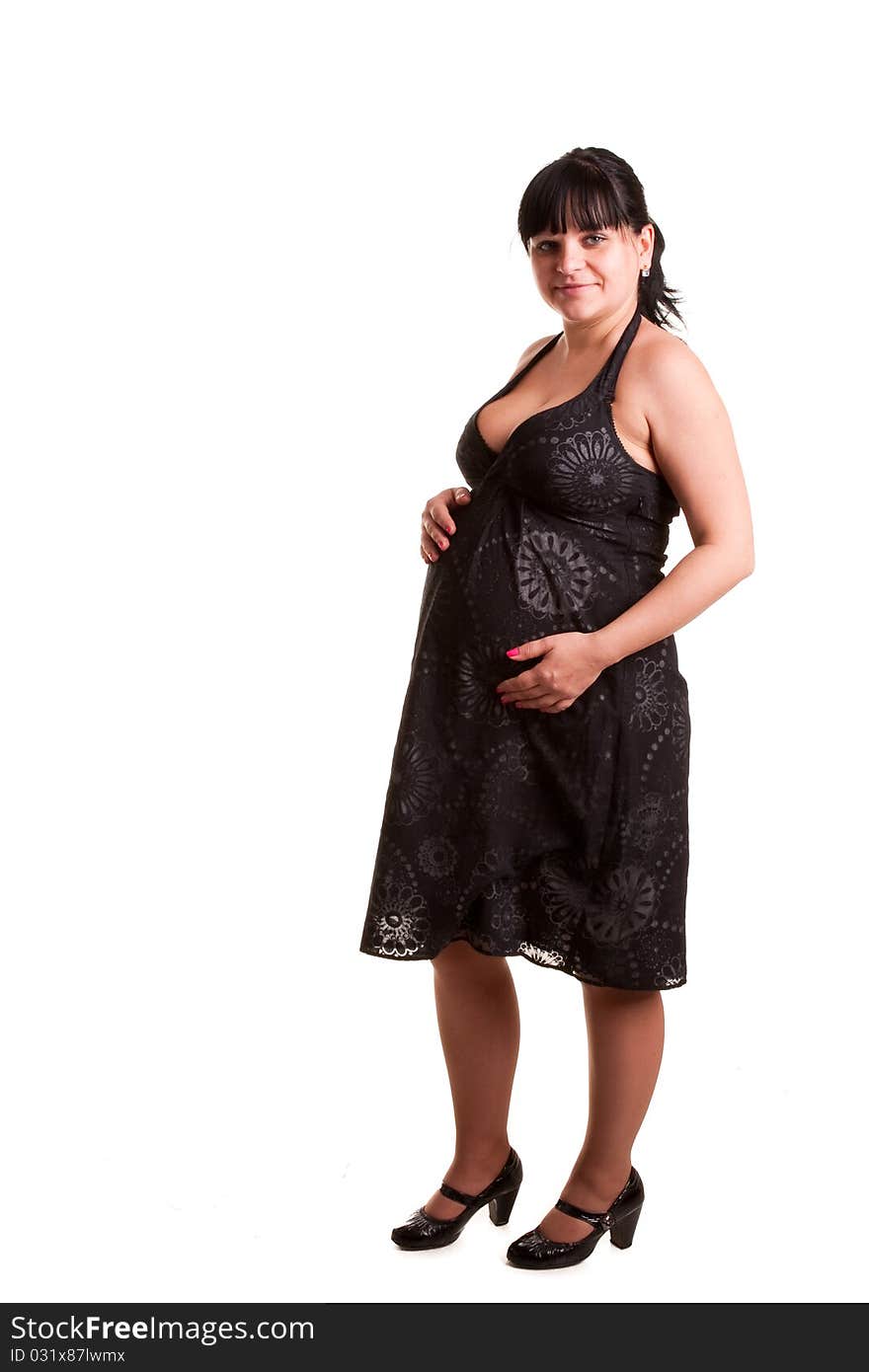 Pregnant woman in black dress on white background